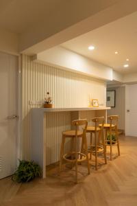 a kitchen and dining room with a table and stools at Tungyu Home Old Town - 1 min to walking street in Chiang Mai