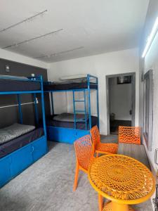 a room with a table and chairs and bunk beds at Green forest BnB and cafe in Manāli