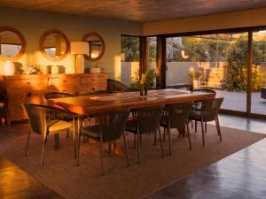 a dining room with a wooden table and chairs at Hideaways Cape Point Hideaway in Cape Town
