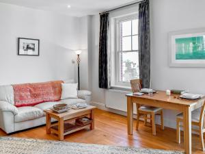 a living room with a couch and a table at Flat 4 Sea Court in Swanage