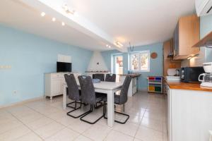 a kitchen with a table and chairs in a room at House Nešpula in Veli Lošinj