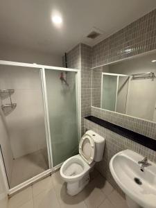 a bathroom with a toilet and a shower and a sink at Regenthome 28A in Bang Su