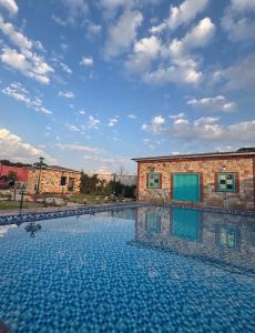 a large swimming pool in front of a building at Mastiff Citadel RC in Chūharpur