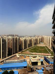 a view of a large city with tall buildings at Hotel Namaste With Jacuzzi I Best For Couples and Corporate I Noida in Noida