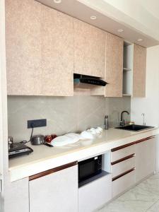 a kitchen with a sink and a counter top at Hotel Namaste With Jacuzzi I Best For Couples and Corporate I Noida in Noida