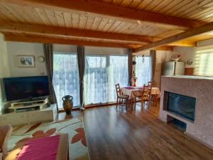 a living room with a table and a fireplace at Doudleby u Českých Budějovic in Doudleby