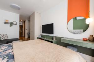 a bedroom with a bed and a mirror at Stella Andrea Luxury Apartment in Bar