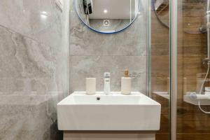 a bathroom with a white sink and a mirror at Stella Andrea Luxury Apartment in Bar +28 photos