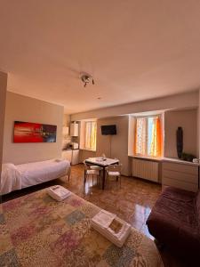 a bedroom with a bed and a table in a room at MONOLOCALI DA VINCI in Falconara Marittima