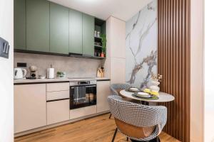 a kitchen with a table and chairs in a room at Stella Andrea Luxury Apartment in Bar