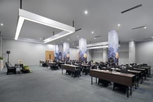 a large dining room with tables and chairs at Radja Art and Boutique Hotel Simpang Lima in Semarang +47 photos