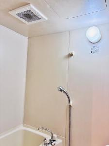 a bathroom with a shower and a bath tub at 蓮子川Room in Hamamatsu +25 photos
