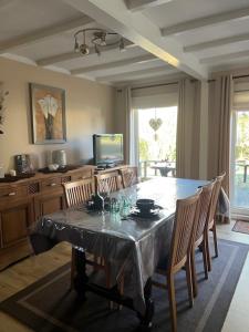 a dining room with a table and some chairs at 't eekhoorntje in Durbuy +19 photos