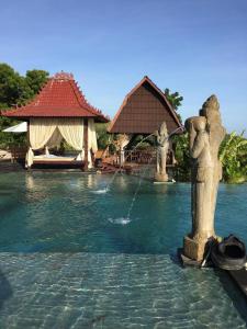 a fountain in the middle of a pool at a resort at Singa Villas in Ungasan