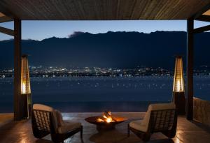 a room with a fireplace and a view of the water at Arcadia anyin qingshan hotel in Dali Shuanglang +119 photos