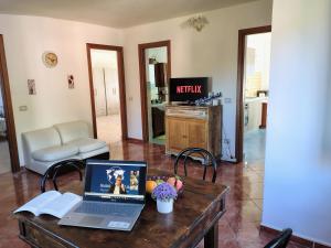 a laptop computer sitting on a table in a living room at Casa Gioele by Holiday World in Bove