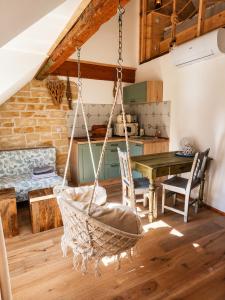 a room with a hammock in a kitchen with a table at Trapani house & camp in Růžová +99 photos