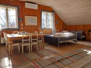 a dining room with a table and a bed at Gyttja Västergårds in Nauvo