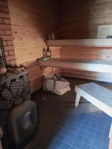 a room with a bench and a table and a stove at Gyttja Västergårds in Nauvo +40 photos
