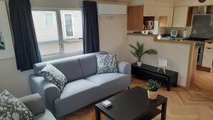 a living room with a couch and a table at Luiwagen in Raalte +15 photos