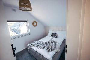 a small bedroom with a bed and a window at Skorzęcin Rybakówka Resort in Skorzęcin +35 photos