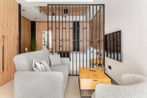 a living room with a couch and a table at Elcano Suites in Seville