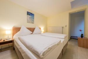 Postel nebo postele na pokoji v ubytování Hotel Windsor