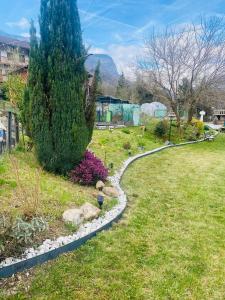 a garden with a winding path in the grass at Casa Gallo Music Room in Lamon