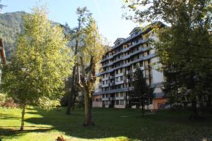 a building in the middle of a park with trees at Apartment Chamois Blanc 2B in Chamonix