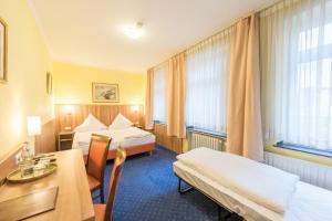 Postel nebo postele na pokoji v ubytování Hotel Windsor