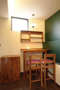 a room with a desk and two chairs and a table at Outside Space Resorts in Lovedale +28 photos