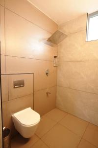 a small bathroom with a toilet and a window at Outside Space Resorts in Lovedale