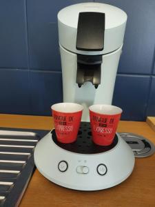 a coffee maker with two cups on top of it at Les Bains de Mers in Mers-les-Bains +16 photos