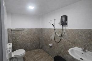 a bathroom with a shower and a toilet and a sink at Sigiriya River Side Resort in Sigiriya +80 photos