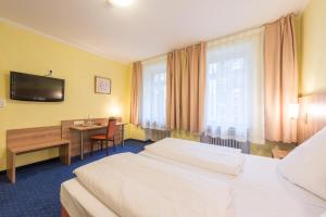 Postel nebo postele na pokoji v ubytování Hotel Windsor