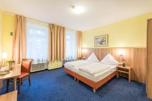 Postel nebo postele na pokoji v ubytování Hotel Windsor
