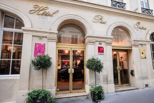 a store front of a building with plants in front at Hotel Pax Opera in Paris