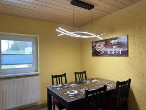 a dining room with a table and a window at Ferienhaus in Altenfeld Thüringen mit Garten in Altenfeld