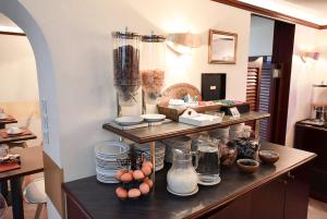 a kitchen with a counter with plates and eggs on it at Hotel Pax Opera in Paris