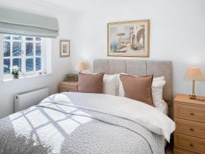 a bedroom with a bed and two night stands at Bay Cottage in Ripon