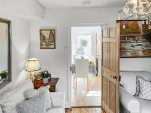 a living room with a couch and a table at Bay Cottage in Ripon +9 photos