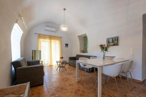 a living room with a table and a couch at Green Blue Kardamyli in Kardamyli