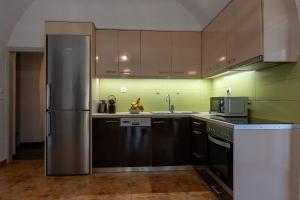 a kitchen with a stainless steel refrigerator at Green Blue Kardamyli in Kardamyli