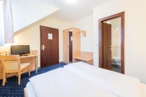 Postel nebo postele na pokoji v ubytování Hotel Windsor