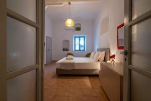 a bedroom with a bed and a window and a door at Green Blue Kardamyli in Kardamyli