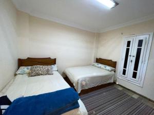 a room with two beds and a window at Private Bella Rum Villa with Garden in Marsa Matruh