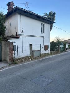 a white house on the side of a street at Pino Center in Pino Torinese