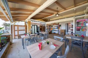 a restaurant with tables and chairs in a room at Pension Elena in Ágios Nikólaos