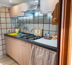 a kitchen with a stove and a counter top at La dimora di nonna Giuseppa in Pachino