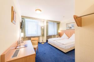 Postel nebo postele na pokoji v ubytování Hotel Windsor